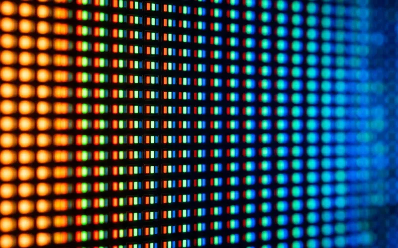 Macro close-up photography of a TV screen showing individual RGB sub-pixels